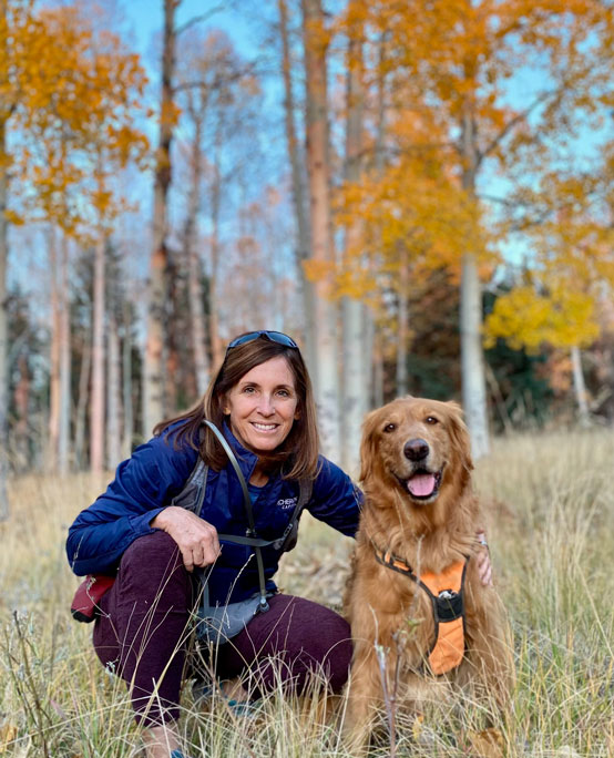 golden retriever and woman in field
